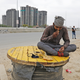 A migrant worker eats food offered by local residents on a highway in Ghaziabad.